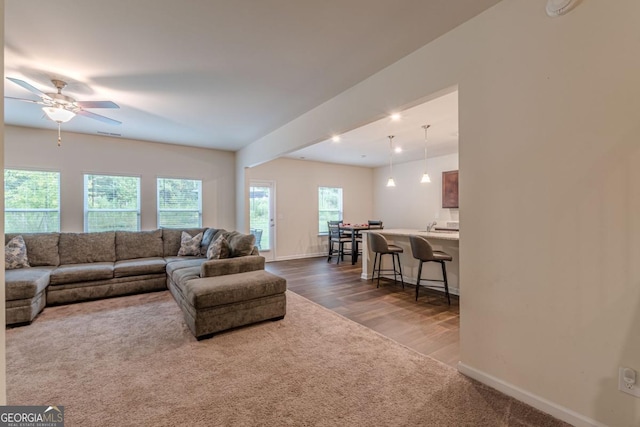 9061 Jim Purcell Dr, Covington, GA 30014 - living area featuring ceiling fan, dark wood finished floors, recessed lighting, and dark colored carpet