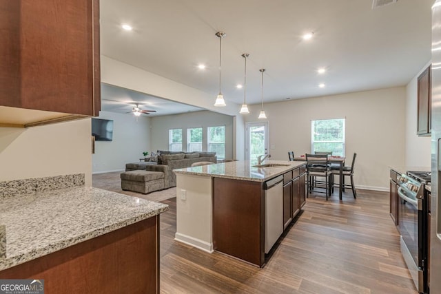 9061 Jim Purcell Dr, Covington, GA 30014 - kitchen with stainless steel appliances, dark wood-style floors, healthy amount of natural light, a ceiling fan, and recessed lighting