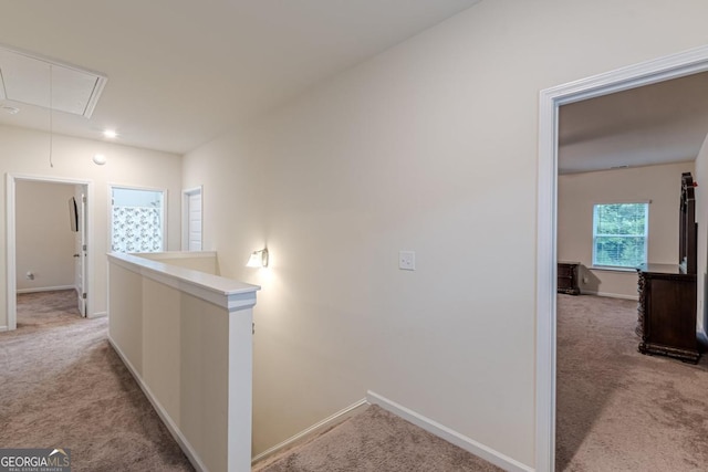 9061 Jim Purcell Dr, Covington, GA 30014 - hallway featuring attic access, light colored carpet, and an upstairs landing