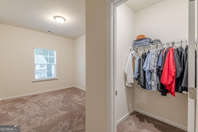 9061 Jim Purcell Dr, Covington, GA 30014 - walk in closet featuring carpet flooring