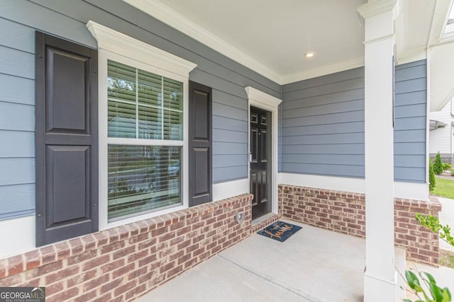 9061 Jim Purcell Dr, Covington, GA 30014 - doorway to property with covered porch and brick siding
