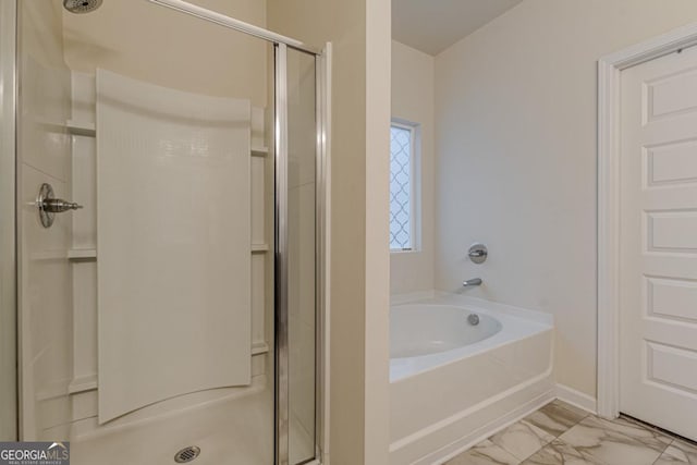 9061 Jim Purcell Dr, Covington, GA 30014 - full bathroom featuring a stall shower, a bath, and marble look tile flooring