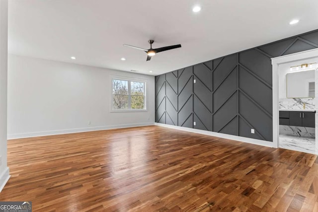 387 S Howard St SE, Atlanta, GA 30317 - spare room featuring wood finished floors, ceiling fan, a decorative wall, an accent wall, and recessed lighting