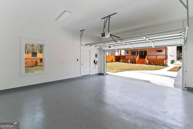 387 S Howard St SE, Atlanta, GA 30317 - garage featuring a garage door opener and baseboards