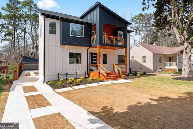 387 S Howard St SE, Atlanta, GA 30317 - modern home with a balcony, board and batten siding, a detached garage, and concrete driveway