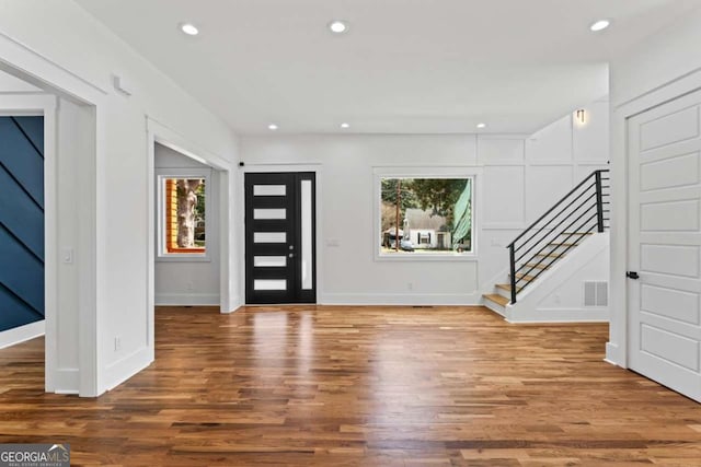 387 S Howard St SE, Atlanta, GA 30317 - foyer entrance with stairway, wood finished floors, and recessed lighting