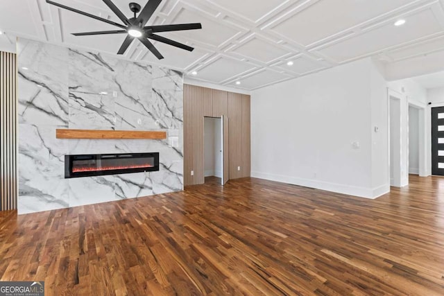 387 S Howard St SE, Atlanta, GA 30317 - unfurnished living room featuring a stone fireplace, wood finished floors, recessed lighting, a ceiling fan, and coffered ceiling