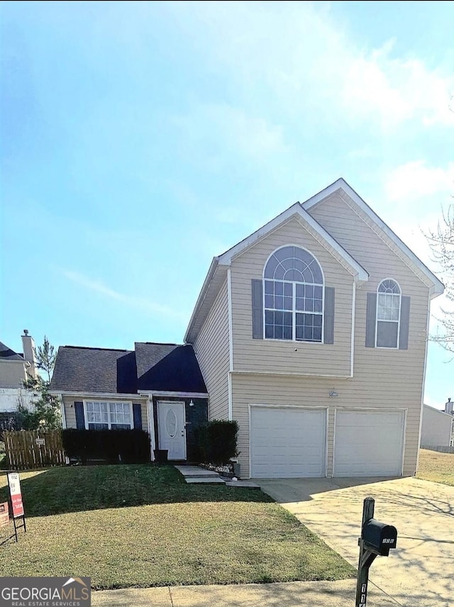 view of front of property featuring a front yard, driveway, and a garage