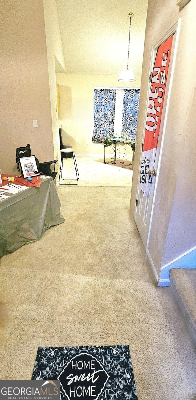 hallway featuring stairway and carpet