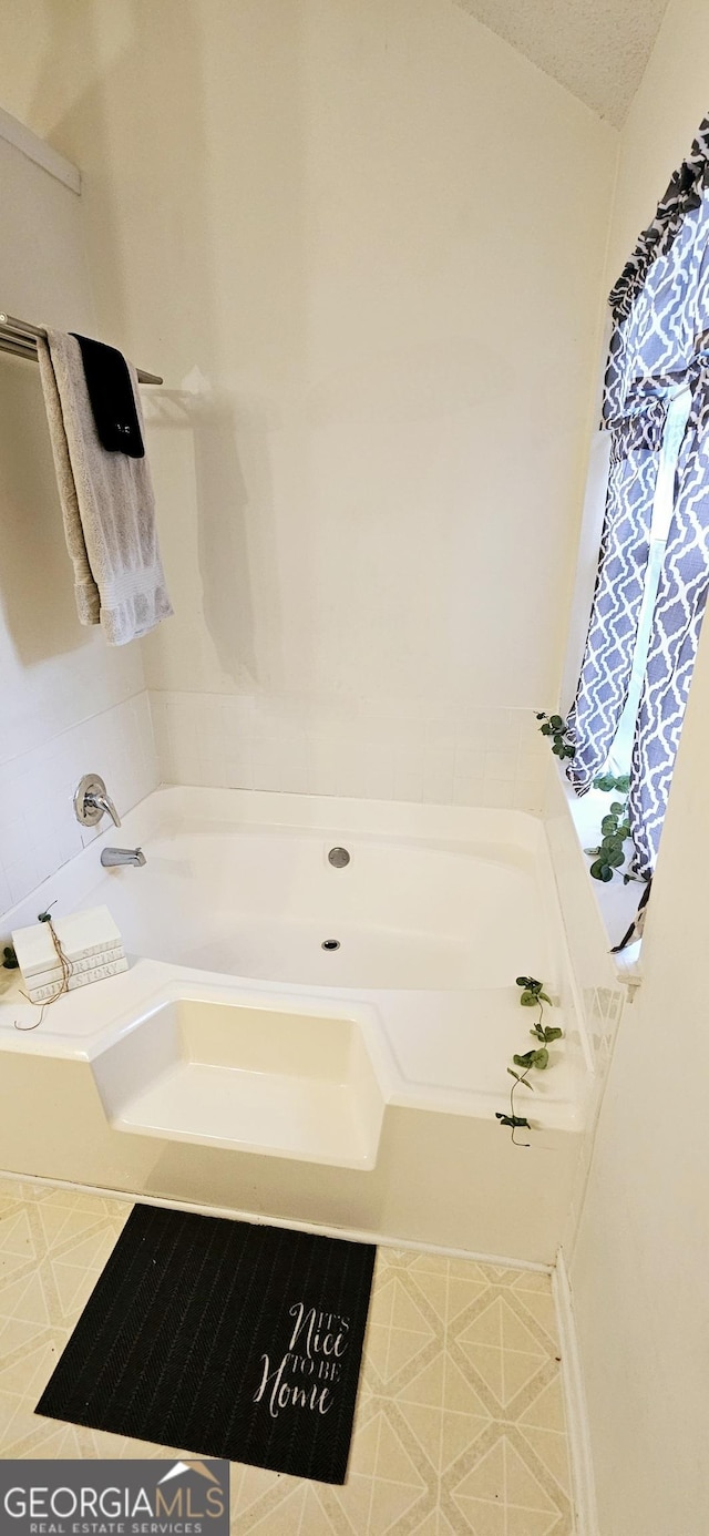 bathroom featuring a tub to relax in