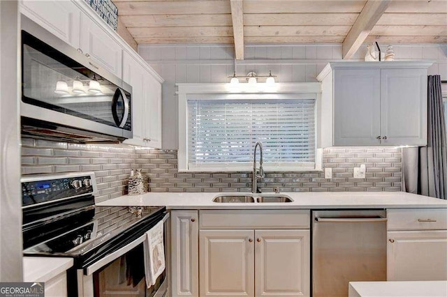 kitchen with light countertops, wooden ceiling, a sink, and stainless steel appliances