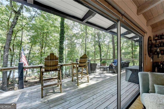 unfurnished sunroom featuring beamed ceiling