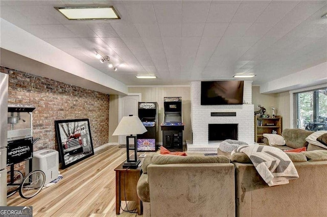 living room with light wood finished floors and a fireplace