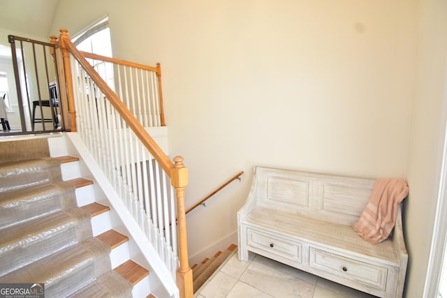 stairs with tile patterned flooring and baseboards