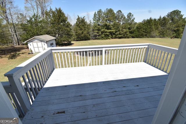 deck with a lawn, a storage shed, and an outdoor structure