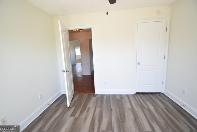 unfurnished bedroom featuring wood finished floors and baseboards