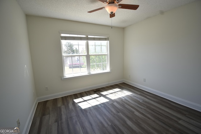 unfurnished room featuring dark wood-style flooring, ceiling fan, baseboards, and a textured ceiling