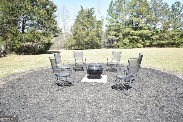 view of yard with a patio and an outdoor fire pit