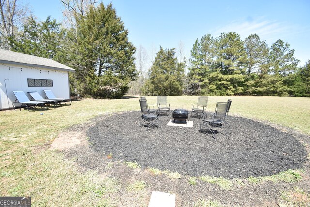 view of yard featuring an outdoor fire pit
