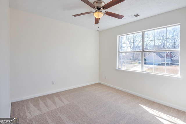 4785 Beaver Rd, Loganville, GA 30052 - carpeted spare room with baseboards, visible vents, a textured ceiling, and a ceiling fan