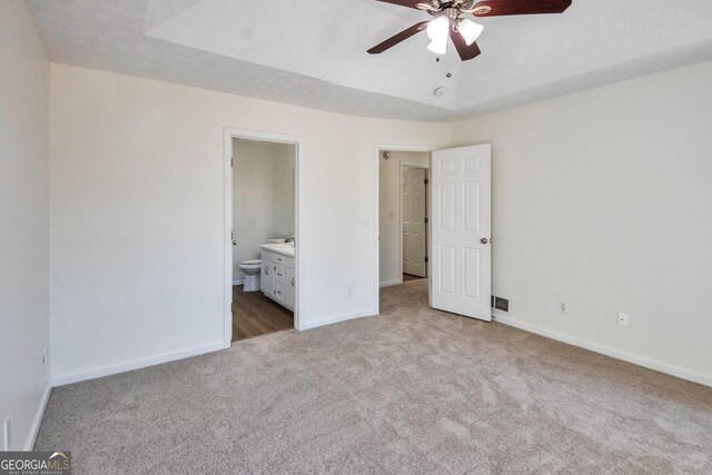 4785 Beaver Rd, Loganville, GA 30052 - unfurnished bedroom with a tray ceiling, baseboards, carpet floors, and ensuite bathroom