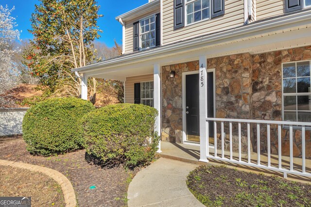4785 Beaver Rd, Loganville, GA 30052 - entrance to property with stone siding and covered porch