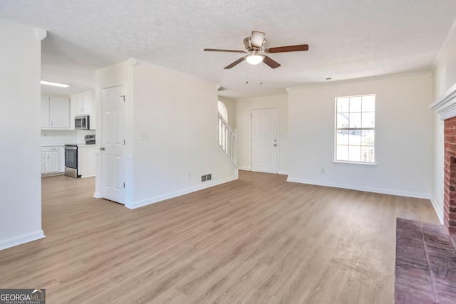 4785 Beaver Rd, Loganville, GA 30052 - unfurnished living room with a ceiling fan, visible vents, a fireplace, and light wood-type flooring