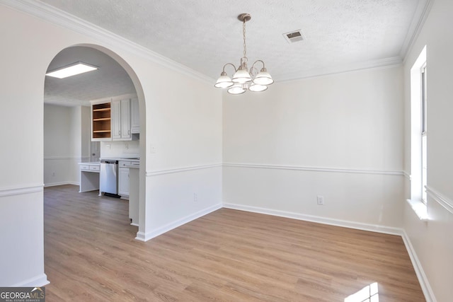 4785 Beaver Rd, Loganville, GA 30052 - unfurnished dining area with a textured ceiling, light wood-style flooring, visible vents, a chandelier, and arched walkways