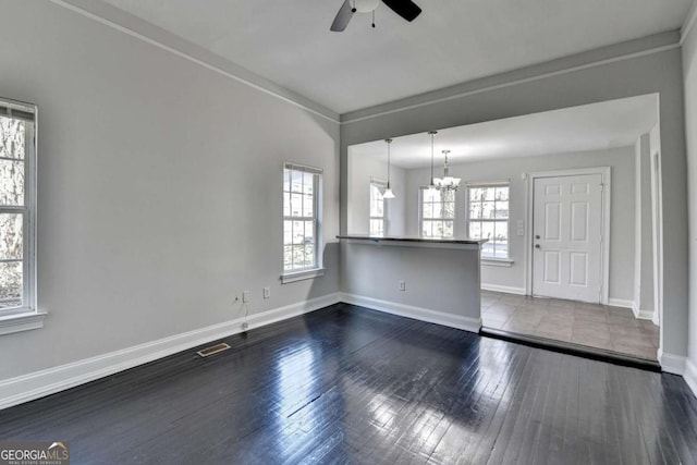 73 Atlanta Ave SW, Atlanta, GA 30315 - empty room featuring dark wood finished floors, ceiling fan with notable chandelier, visible vents, and baseboards