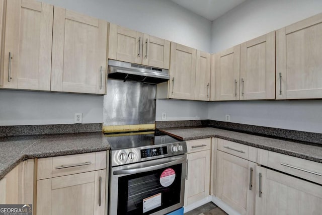 73 Atlanta Ave SW, Atlanta, GA 30315 - kitchen with dark countertops, light brown cabinets, under cabinet range hood, and stainless steel electric range