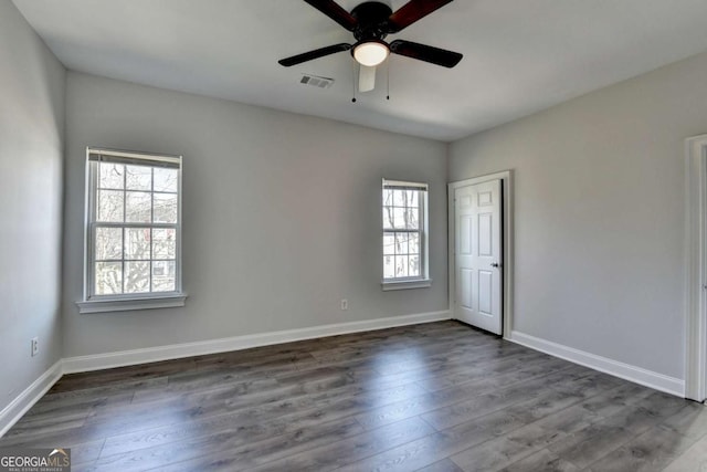 73 Atlanta Ave SW, Atlanta, GA 30315 - spare room featuring baseboards, dark wood-style flooring, ceiling fan, and visible vents