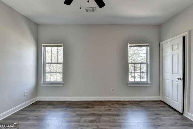 73 Atlanta Ave SW, Atlanta, GA 30315 - unfurnished bedroom featuring dark wood-style floors, visible vents, baseboards, and a ceiling fan