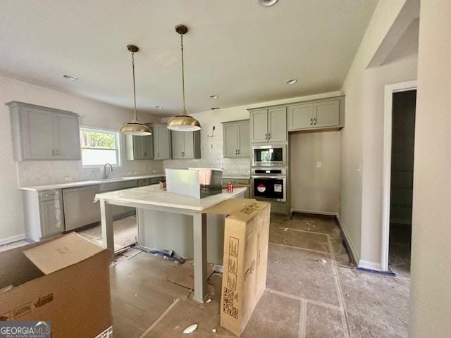 27 Sagebrook Ln Lot 1, Newnan, GA 30263 - kitchen with appliances with stainless steel finishes, tasteful backsplash, gray cabinets, light countertops, and hanging light fixtures