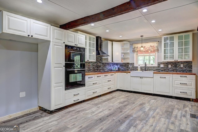 12 John Boy Trl, Newnan, GA 30263 - kitchen with wall chimney range hood, butcher block countertops, light wood finished floors, recessed lighting, and decorative backsplash