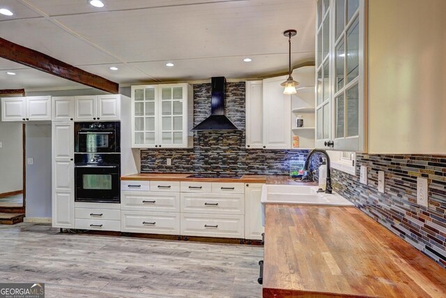 12 John Boy Trl, Newnan, GA 30263 - kitchen featuring butcher block countertops, wall chimney exhaust hood, a sink, backsplash, and recessed lighting