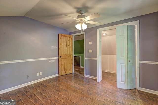12 John Boy Trl, Newnan, GA 30263 - unfurnished bedroom featuring vaulted ceiling, wood finished floors, baseboards, and ceiling fan