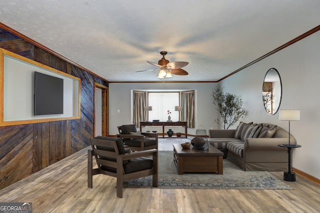 12 John Boy Trl, Newnan, GA 30263 - living area featuring ornamental molding, a ceiling fan, wood walls, wood finished floors, and baseboards