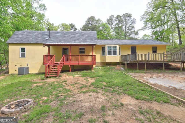 12 John Boy Trl, Newnan, GA 30263 - view of front facade featuring cooling unit, a deck, an outdoor fire pit, stairs, and roof with shingles