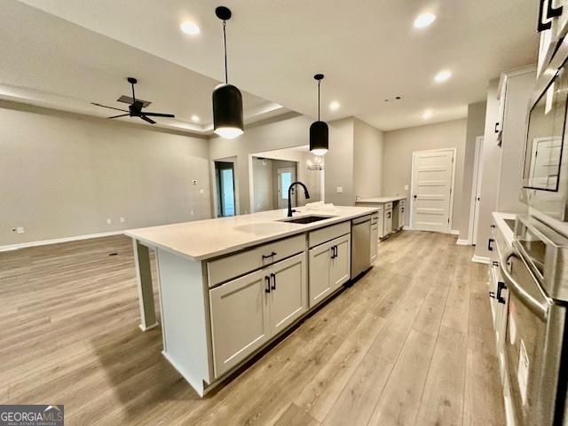 149 Sagebrook Ln Lot 8, Newnan, GA 30263 - kitchen with appliances with stainless steel finishes, light wood-style floors, a sink, a center island with sink, and open floor plan