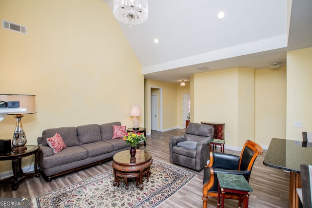 207 Meadow Lake Dr, Carrollton, GA 30116 - living area featuring wood finished floors, recessed lighting, a chandelier, a high ceiling, and baseboards