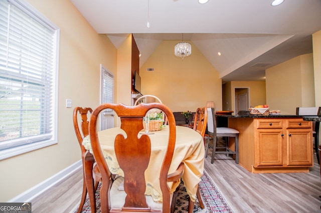 207 Meadow Lake Dr, Carrollton, GA 30116 - dining area with light wood-type flooring, recessed lighting, a chandelier, baseboards, and vaulted ceiling