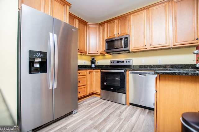 207 Meadow Lake Dr, Carrollton, GA 30116 - kitchen with appliances with stainless steel finishes, light wood-type flooring, and dark stone countertops