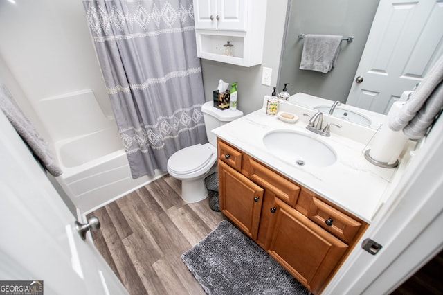 207 Meadow Lake Dr, Carrollton, GA 30116 - full bathroom with wood finished floors, vanity, toilet, and shower / bathtub combination with curtain