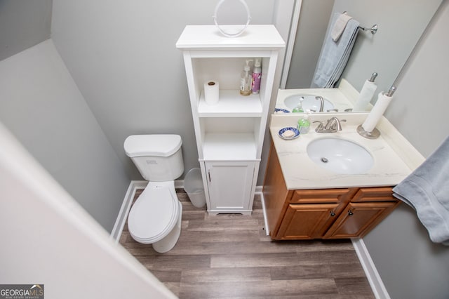 207 Meadow Lake Dr, Carrollton, GA 30116 - half bathroom featuring toilet, wood finished floors, and vanity