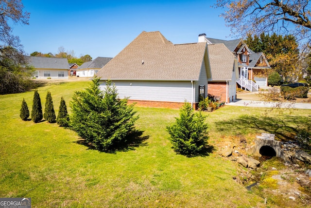 207 Meadow Lake Dr, Carrollton, GA 30116 - view of side of property featuring a yard, a chimney, brick siding, and a shingled roof