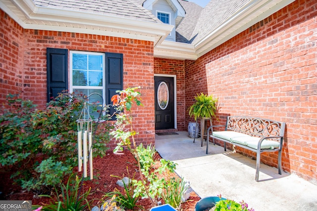 207 Meadow Lake Dr, Carrollton, GA 30116 - doorway to property featuring brick siding and roof with shingles