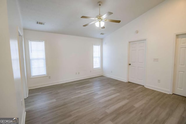 107 Griffith St, Winder, GA 30680 - spare room with a ceiling fan, vaulted ceiling, plenty of natural light, and wood finished floors