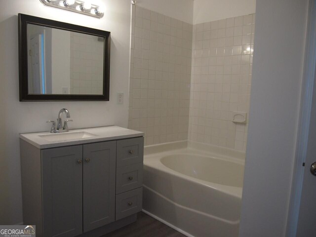 107 Griffith St, Winder, GA 30680 - bathroom with a bathing tub, wood finished floors, and vanity