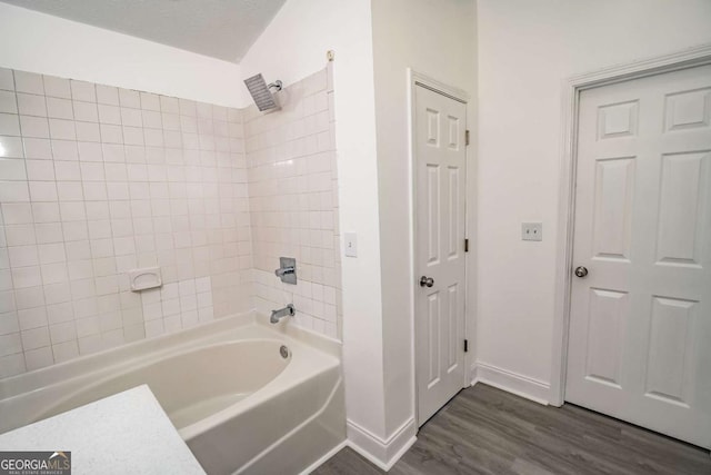 107 Griffith St, Winder, GA 30680 - full bath featuring baseboards, washtub / shower combination, and wood finished floors