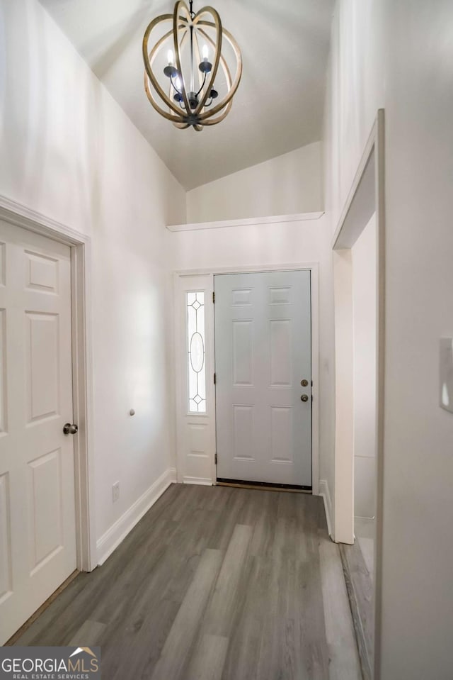 107 Griffith St, Winder, GA 30680 - foyer entrance featuring an inviting chandelier, baseboards, vaulted ceiling, and wood finished floors